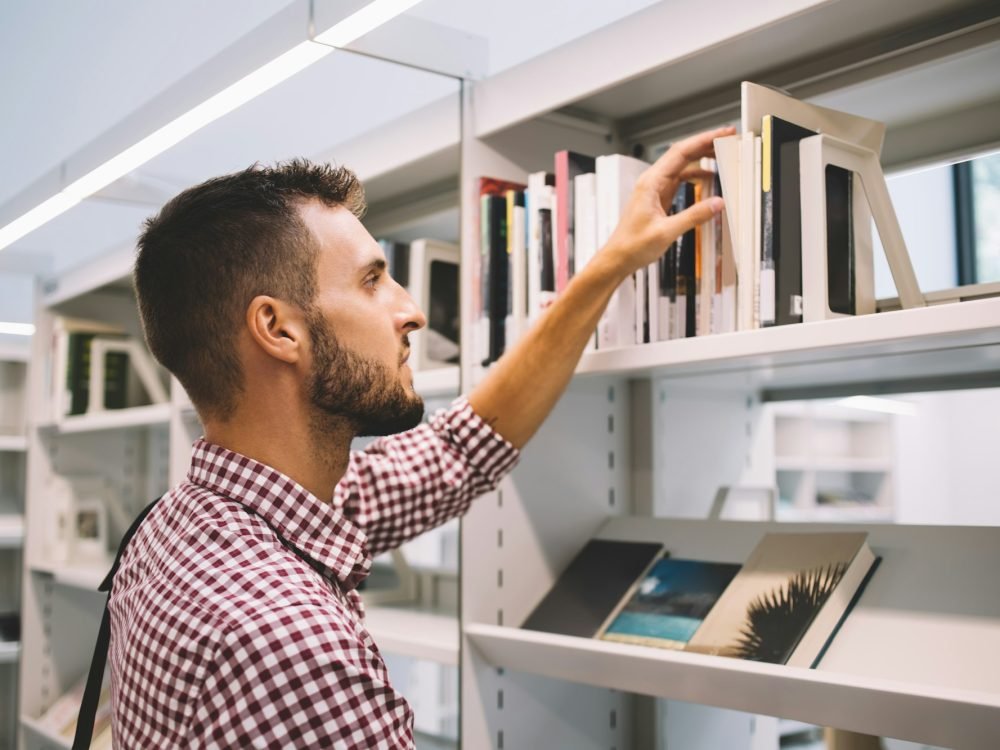 Serious male buying book in bookstore